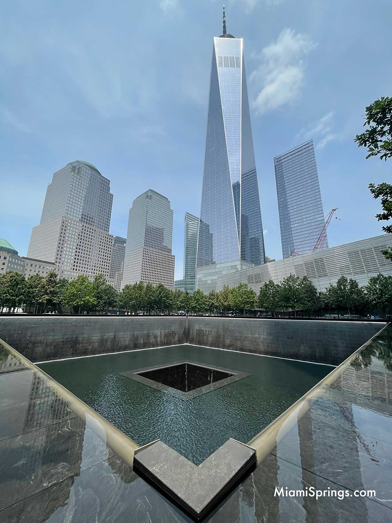 Freedom Tower and Reflection Pond at September 11 Memorial in New York City