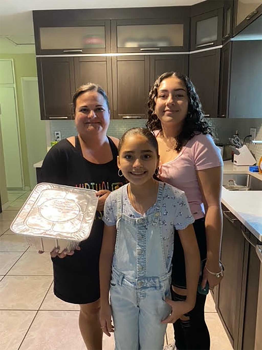 Sopera Family preparing a meal for Camillus House
