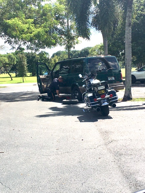 Miami Springs Police Motorman Assisting Driver with Flat Tire (photo credit: Yvette Bunuel)