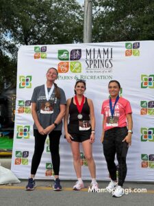 April Hoyt (45 left), Gabriel Guiu-Garcia (41 right), and Isabel Cantor (39 right) at the 2026 River Cities Regatta 5K Run