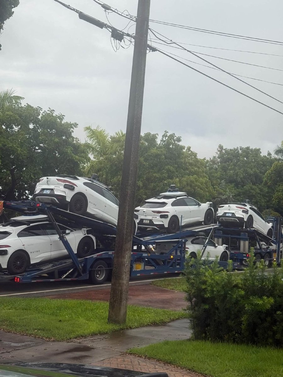 A massive commercial car hauler loaded with Waymo self-driving vehicles cutting through a residential street in Miami Springs. (Photo: Anastasia Yecke Gude)