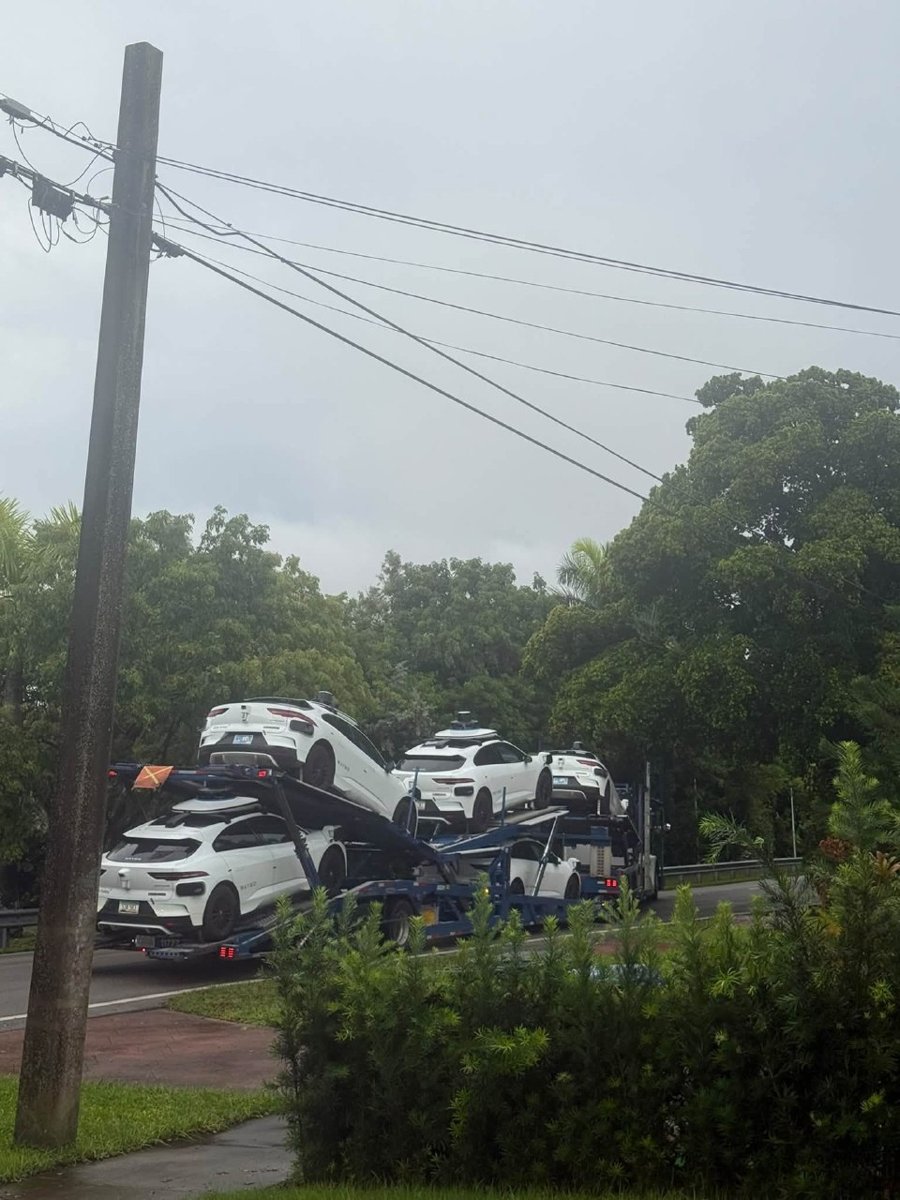 The same commercial car hauler carrying Waymo vehicles navigating the narrow canopy-lined residential streets of Miami Springs. (Photo: Anastasia Yecke Gude)
