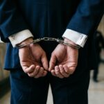 Generic Handcuffed Man in Suit Stock Photo